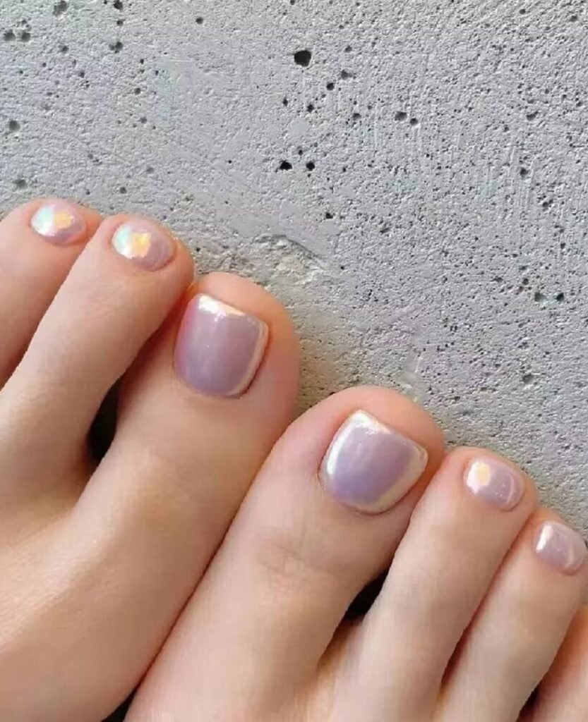 "2025 short toenail trends: minimalist geometric designs in earth tones with chrome accents, Korean-inspired negative space, low-maintenance styles."