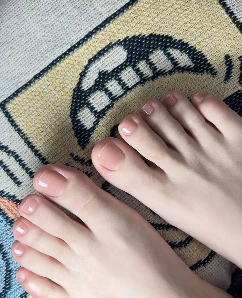 "2025 short toenail trends: minimalist geometric designs in earth tones with chrome accents, Korean-inspired negative space, low-maintenance styles."