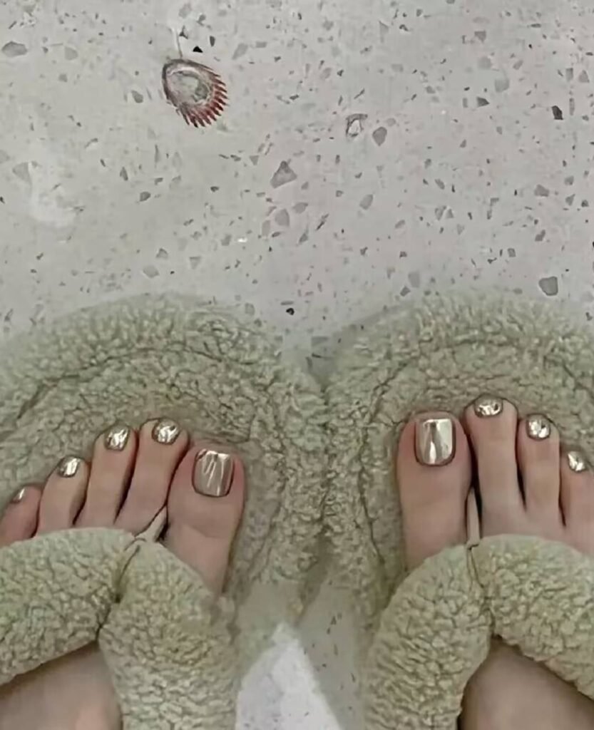 "2025 short toenail trends: minimalist geometric designs in earth tones with chrome accents, Korean-inspired negative space, low-maintenance styles."