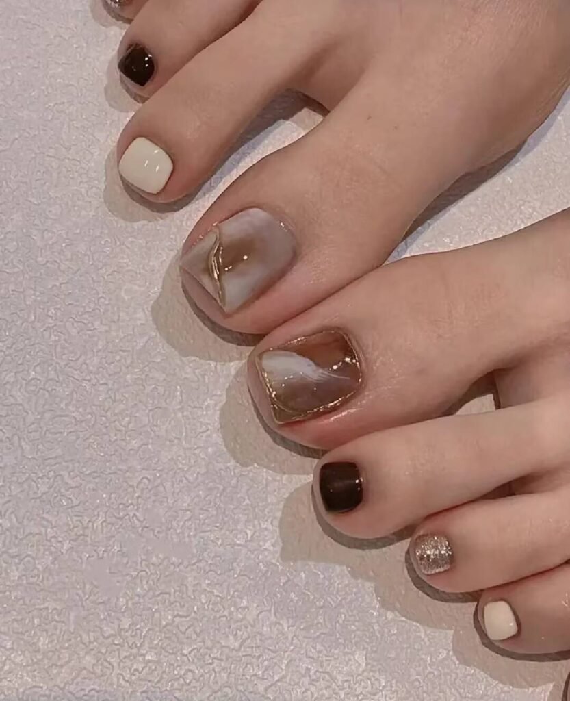 "2025 short toenail trends: minimalist geometric designs in earth tones with chrome accents, Korean-inspired negative space, low-maintenance styles."