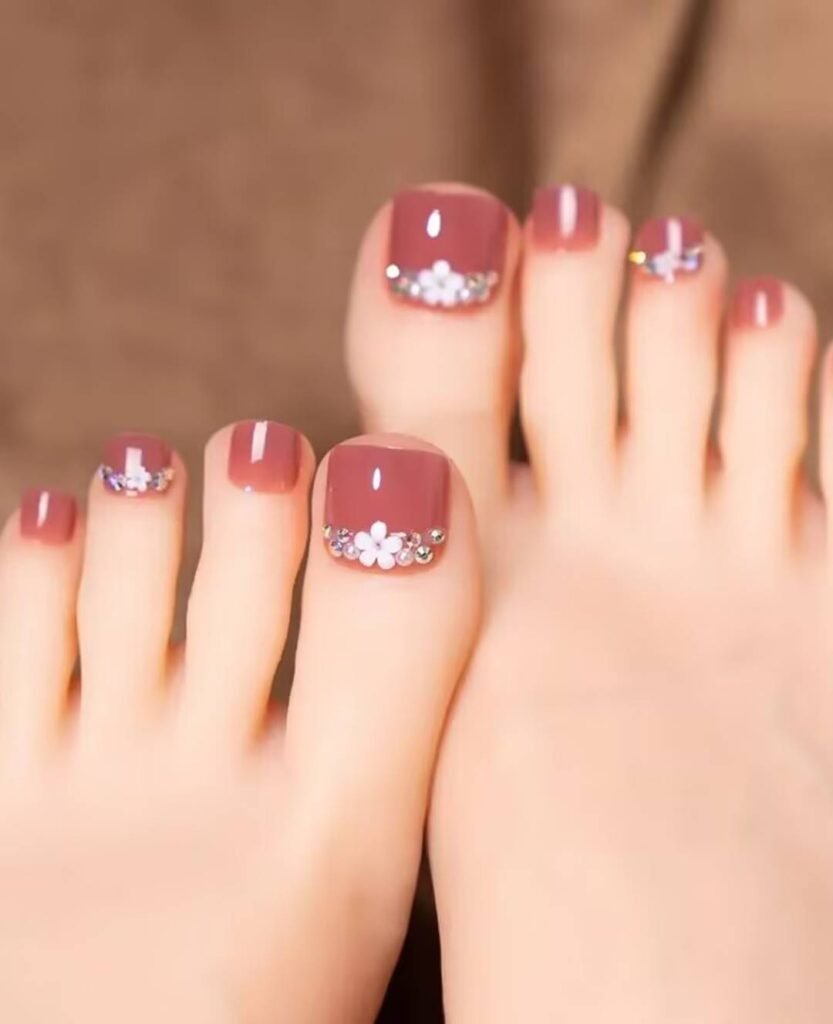 "2025 short toenail trends: minimalist geometric designs in earth tones with chrome accents, Korean-inspired negative space, low-maintenance styles."