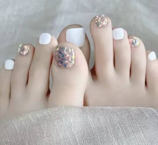 Summer pedicure ideas："Orange-yellow pedicure with coconut pattern for summer sandals"
