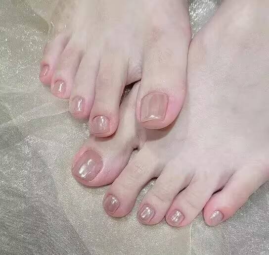 Summer pedicure ideas："Orange-yellow pedicure with coconut pattern for summer sandals"
