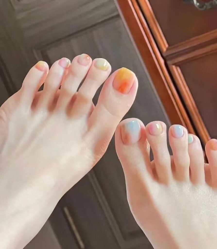 Ankle-flattering pedicures:Cream Shell White Pedicure with minimalist pearl finish - clean toe nail aesthetic