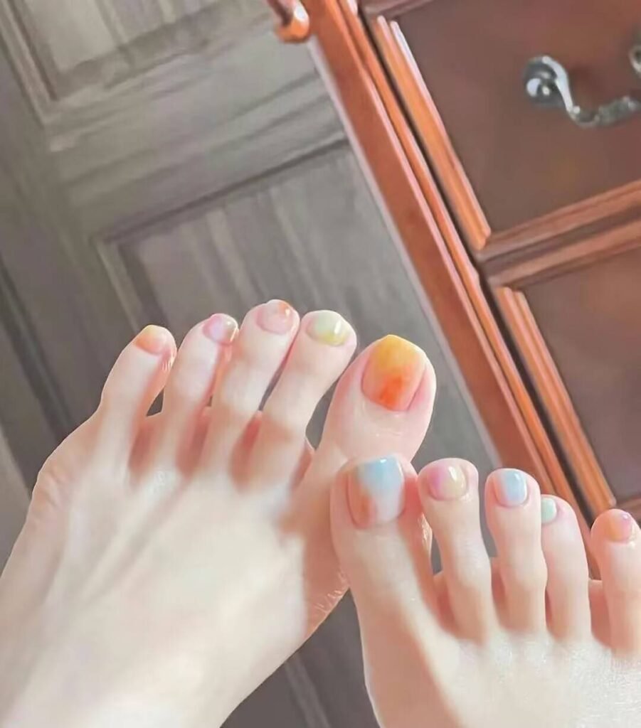 Ankle-flattering pedicures:Cream Shell White Pedicure with minimalist pearl finish - clean toe nail aesthetic