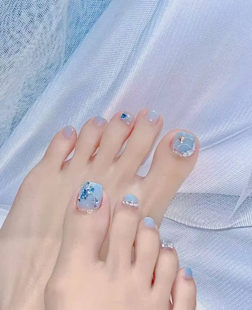Ankle-flattering pedicures:Cream Shell White Pedicure with minimalist pearl finish - clean toe nail aesthetic
