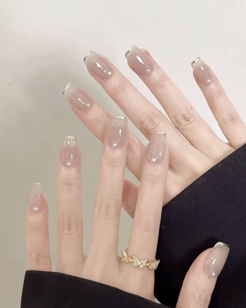 Swatches of flattering nail colors for fair skin: pale pink, peach nude, mauve, and sheer red