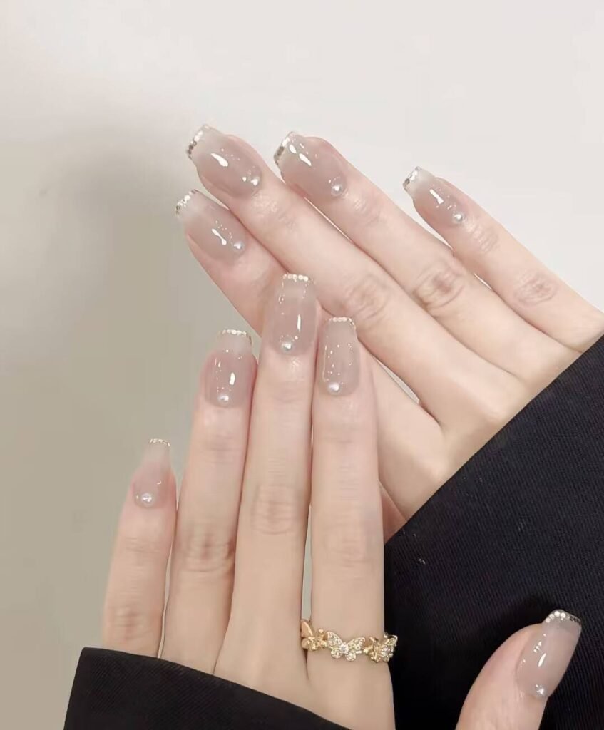 Swatches of flattering nail colors for fair skin: pale pink, peach nude, mauve, and sheer red