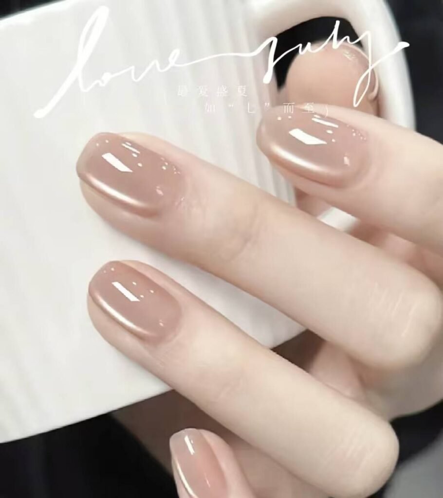 Short, elegant nail designs featuring minimalist styles like French tips, soft nude polish, and delicate gold accents on natural nails.