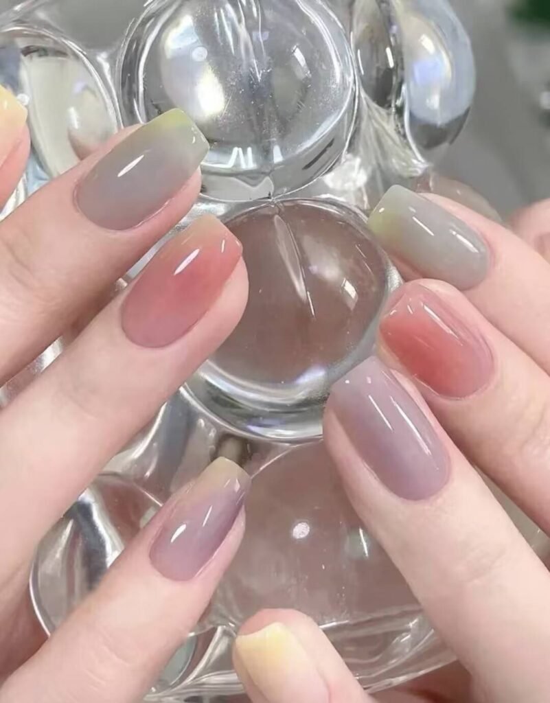 Short, elegant nail designs featuring minimalist styles like French tips, soft nude polish, and delicate gold accents on natural nails.