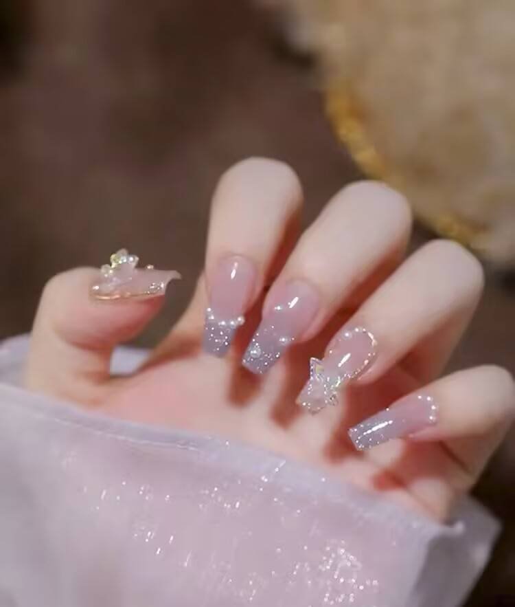 Short, elegant nail designs featuring minimalist styles like French tips, soft nude polish, and delicate gold accents on natural nails.