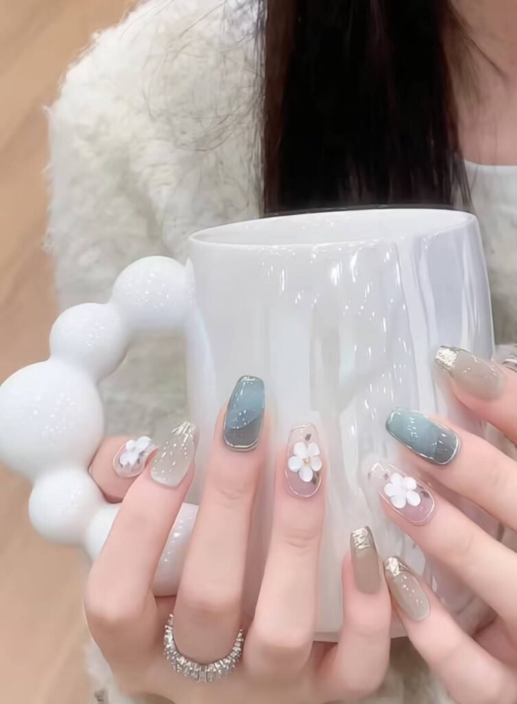 Minimalist spring nail 2025 trends: sheer blush base with subtle chrome half-moon accents.
