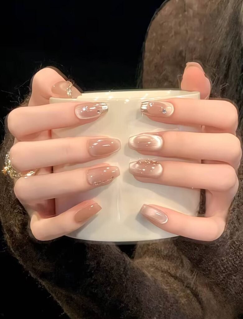 Minimalist spring nail 2025 trends: sheer blush base with subtle chrome half-moon accents.