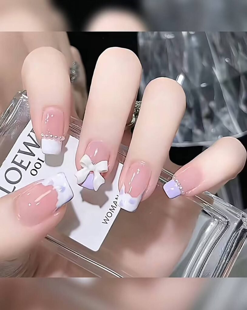 Minimalist spring nail 2025 trends: sheer blush base with subtle chrome half-moon accents.