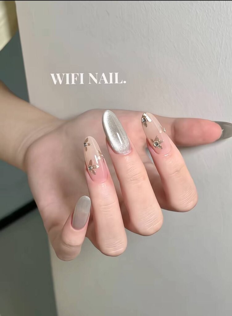 Minimalist spring nail 2025 trends: sheer blush base with subtle chrome half-moon accents.