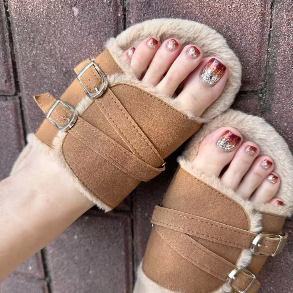 Manicured fair-skinned feet featuring toenails painted in a soft pink shade.