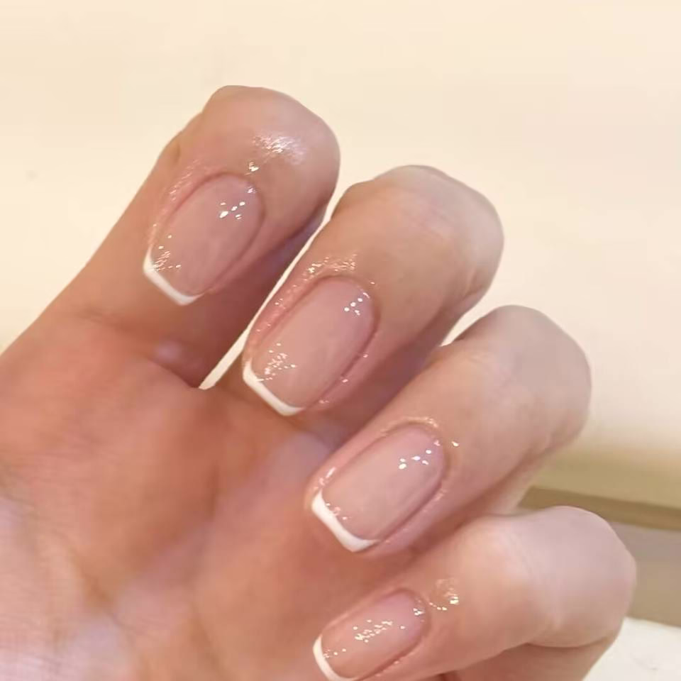 Trending Short Nail Designs: French tip with nude pink base and silver metallic accents
